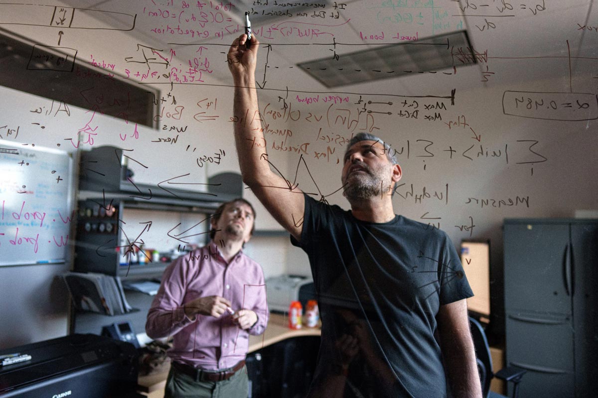 Theoretical computer scientists John Kallaugher, left, and Ojas Parekh find tasks in which quantum computers outperform normal computers, a concept called quantum advantage, at Sandia National Laboratories.