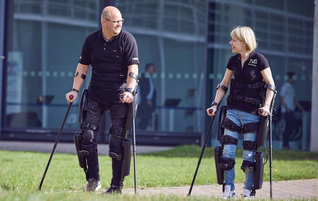 two people walking with Rewalk leg exoskeletons
