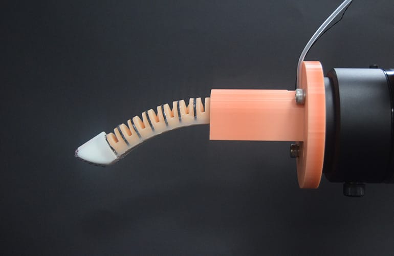 The researchers’ robotic finger contains conductive fiber coils and a twisted liquid-metal fiber at the fingertip.