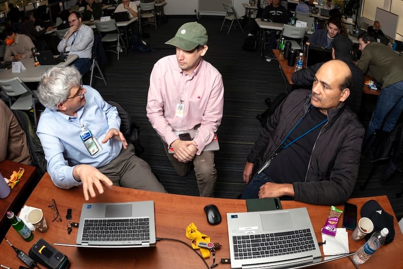 OpenAI researcher Aaron Jaech center assisted Lab scientists in working with AI models at the 1000 Scientist AI Jam Session held in LLNLs Library and the Livermore Valley Open Campus